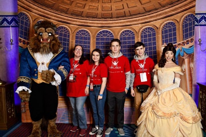 Four children in red T-Shirts and a man and a woman dressed up as the Beauty and the Beast at a Gary...
