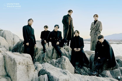 picture of 7 male BTS members on rocks
