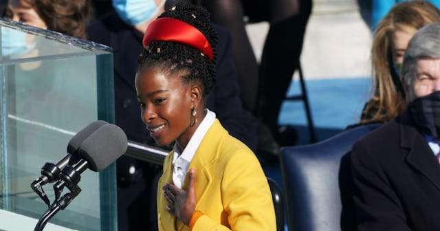 American poet, Amanda Gorman during her speech in a yellow jacket and an orange headband