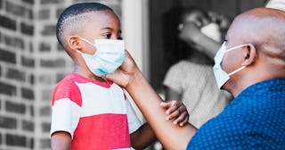 A father and a son wearing masks at school