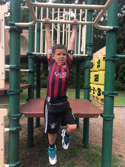 A boy with Type 1 Diabetes at the playground in an FC Barcelona jersey