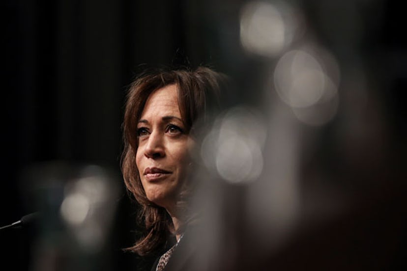 Kamala Harris looking into the distance with blurred elements around her face