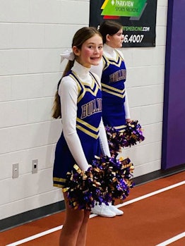 A teenage girl dressed as a cheerleader