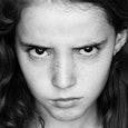 Angry teen looking directly at the camera in a black and white photo 