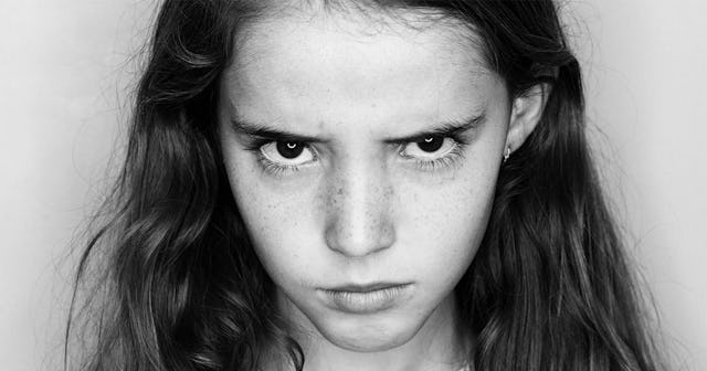 An angry teen looking directly at the camera