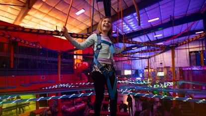 girl hanging from ride at urban air indoor theme park in reno