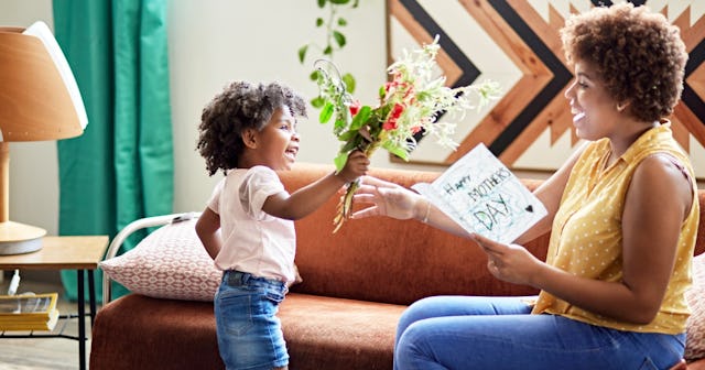 A little boy giving his mother a bouquet on Mother's Day