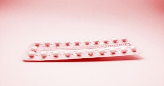 Contraceptive pills on a pink background