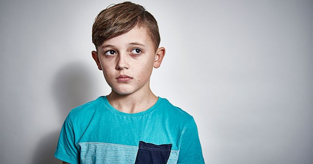 A boy standing with an extreme confusion on his face