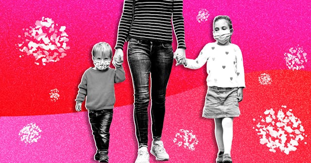 A mom visible only from the chest down, walking while holding her two kids' hands, both of them are ...