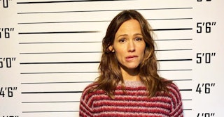 Jennifer Garner posing for a picture in a mugshot room in a police station looking worried