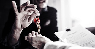 Man Handing Keys To Another Man