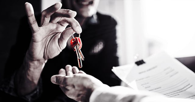 Man Handing Keys To Another Man