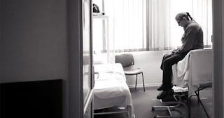 Old woman sitting in the room in hospice 