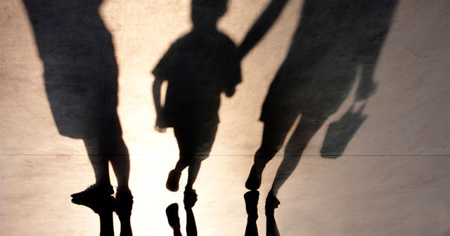 Three shadows of parents and a kid 