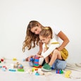 Mom and daughter playing with blocks on the floor