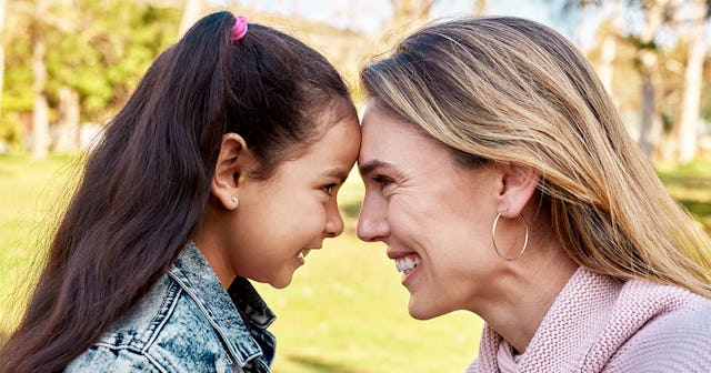 Closeup of a mother and daughter moment, smiling at each other while being very close
