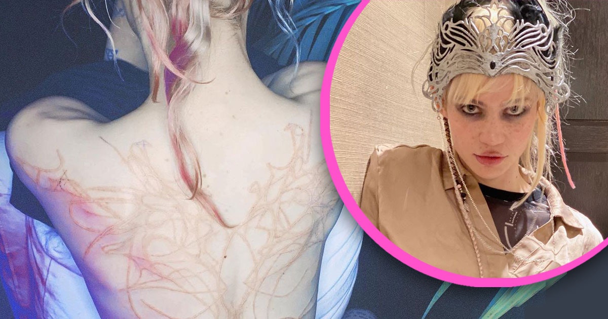 Grimes has a new white ink back tattoo to resemble alien scars