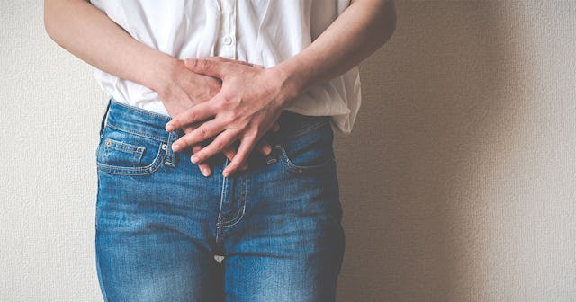 A woman holding her hands over her belly after being diagnosed with Diminished Ovarian Reserve