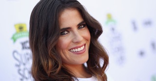 Mexican actress Karla Souza smiling for a photo in a white top