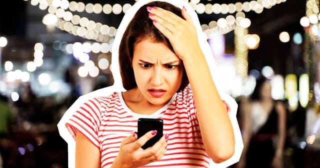 A girl looking at her phone and holding her head being snubbed by her 'gal pals'