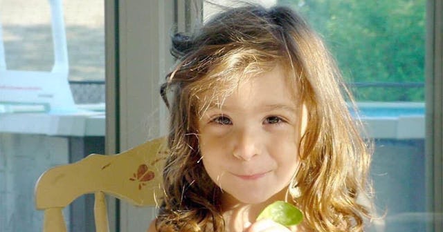 Kathy Radigan's daughter smiling after being left with a giant bag of Easter candy