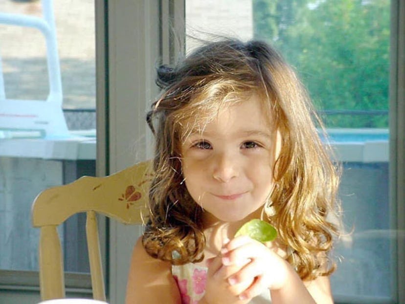 Kathy Radigan's daughter smiling after being left with a giant bag of Easter candy 