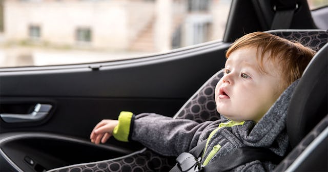 A toddler boy in a cleaned car seat in a car