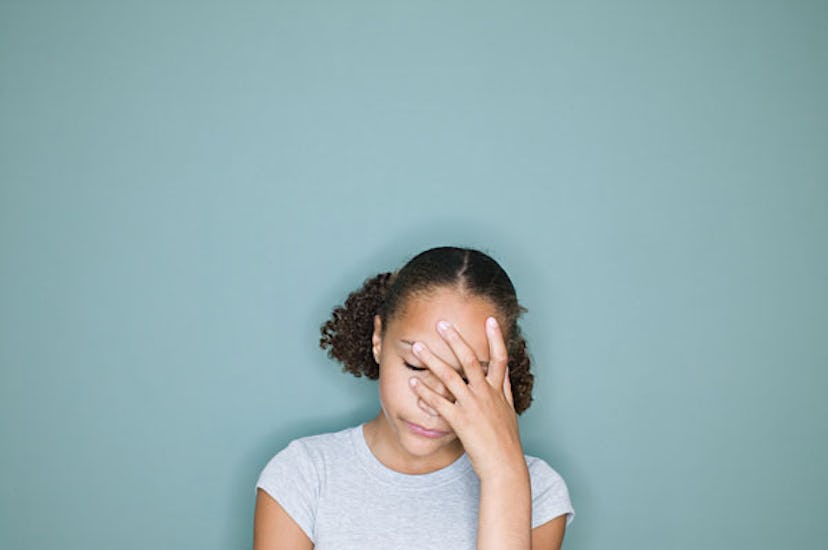 A mother holding her head with her left hand 