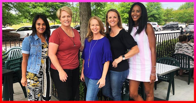 5 women who are all part of a documentary club standing, posing and smiling