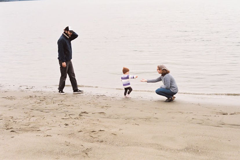 Jessica Myhre and her husband enjoying their time while playing with their kid on a sand beach