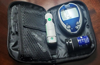 Equipment for measuring Gestational Diabetes in the black case on a wooden table