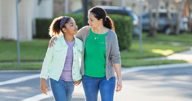 Mother and daughter having a casual talk while walking