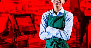A teenager working at the cash register for a minimum wage