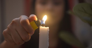 A woman lighting a candle 