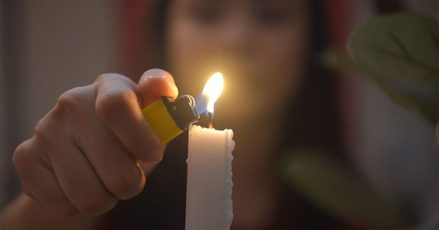 A woman lighting a candle
