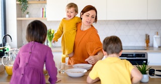A pediatrician mother trying to handle breakfast with her three kids