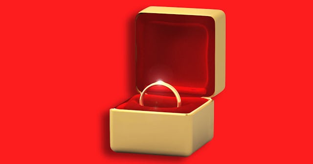 Golden wedding ring in a golden ring box with red velvet padding