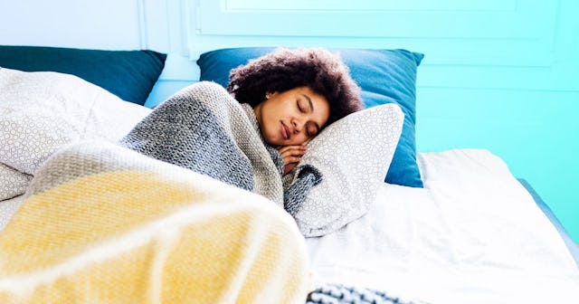 A woman is sleeping peacefully and treating herself like baby