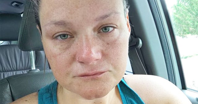 Brynn Burger in a teal tank top sitting in her car looking straight into the camera's direction