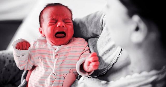 A mother holding her crying baby