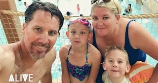 Natalie Livingston's family taking a picture at a swimming pool in bikinis and swimwear