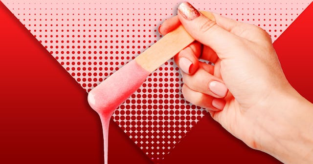 A female hand holding a waxing stick