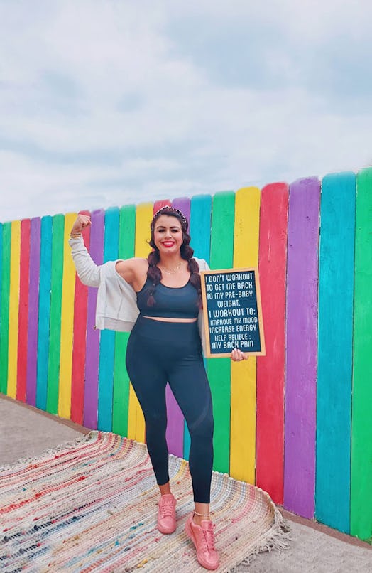 A social media influencer showing strength and holding a chalkboard with text about encouraging her ...