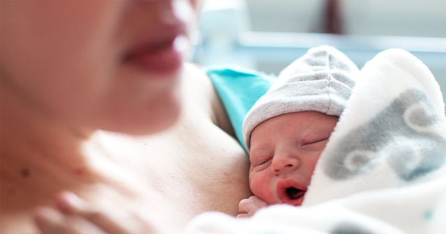Mom holding her baby in a hospital bed