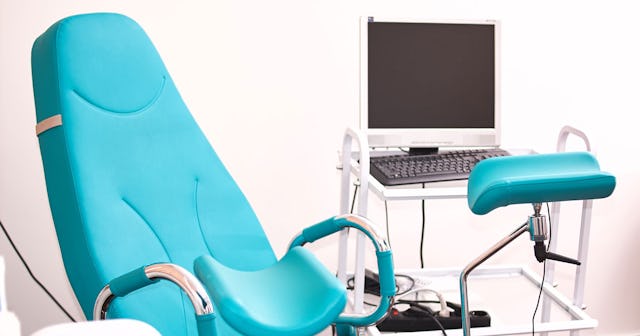 Equipment inside the office of a pelvic floor physical therapist containing a blue chair and a compu...