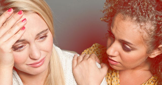 A woman crying because of her divorce and her friend comforting her