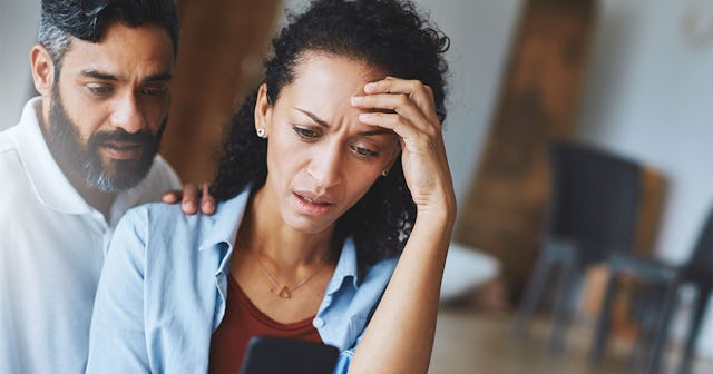 A husband consoling his wife, who is worried about their missing daughter, by placing his hand on he...