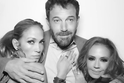 Jennifer Lopez and Leah Remini stand on either side of Ben Affleck, who has his arms around their sh...