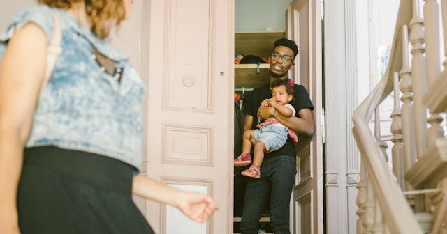 A mother leaving the house for a girls' trip and the father holding their baby